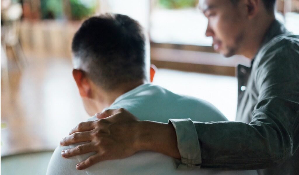 man comforting elderly man - long-term care