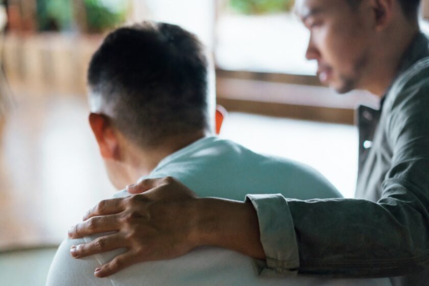 man comforting elderly man - long-term care